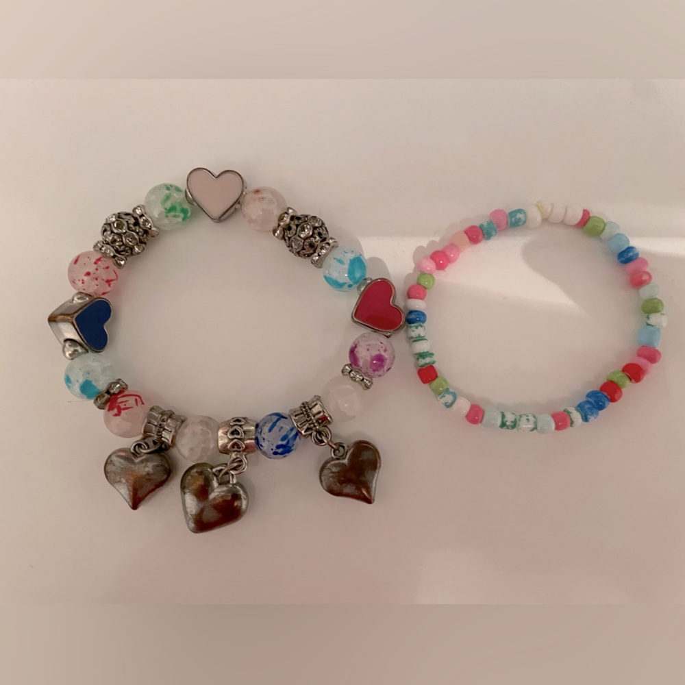 2 bracelets, one charm bracelet and one beaded bracelet